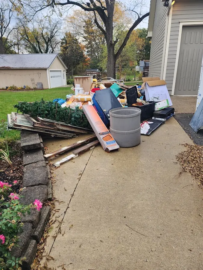 Dumpster being loaded with debris for Estate Cleanout Dumpster Rental in Gillette